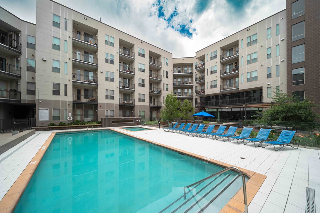 A large swimming pool in front of apartment buildings at Regatta Sloans Lake Apartments, Denver 80204