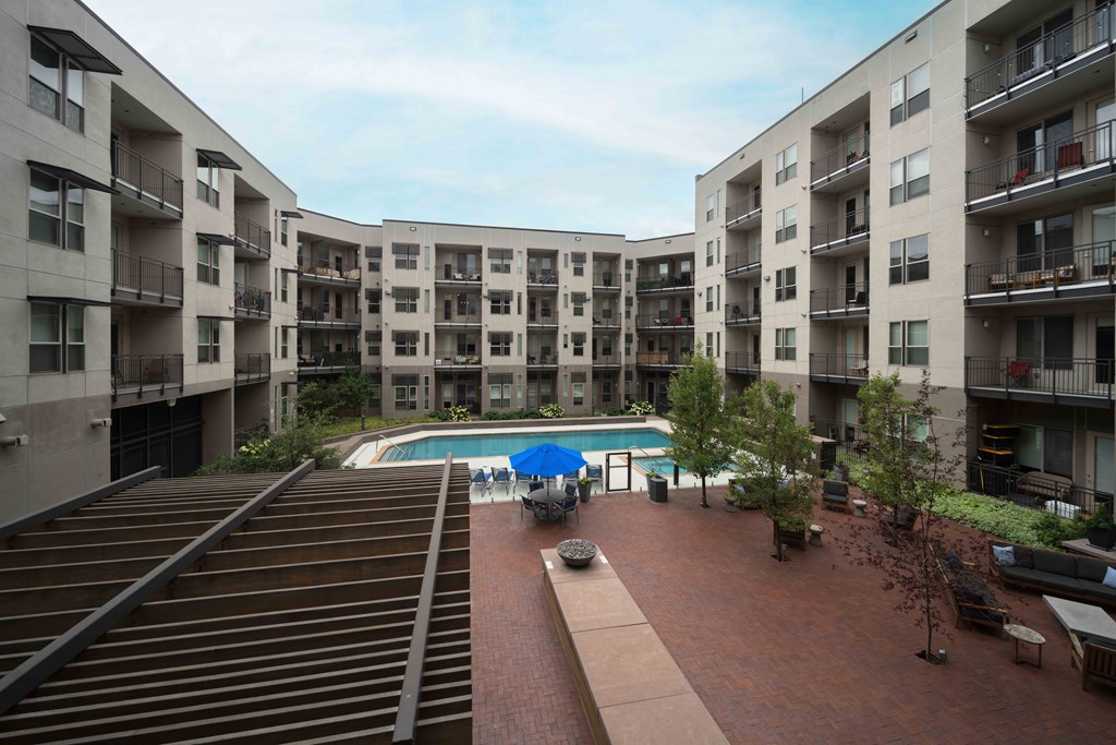 Apartment complex with a pool in the middle at Regatta Sloans Lake Apartments, Denver, CO