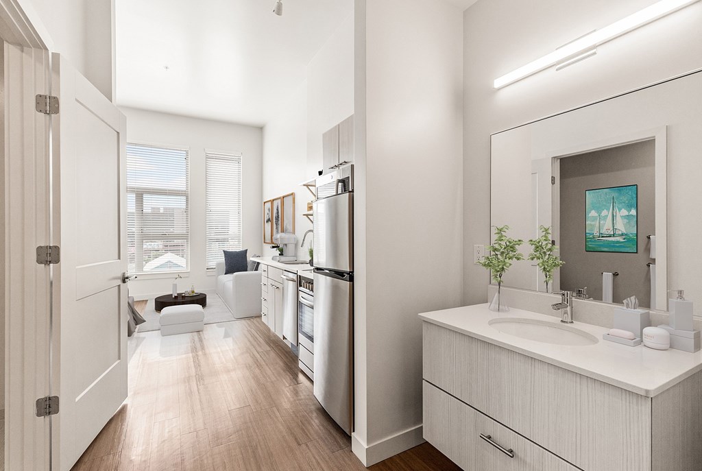 A modern kitchen with white appliances and a white sink. at RiDE at RiNo Apartments, Denver 80216