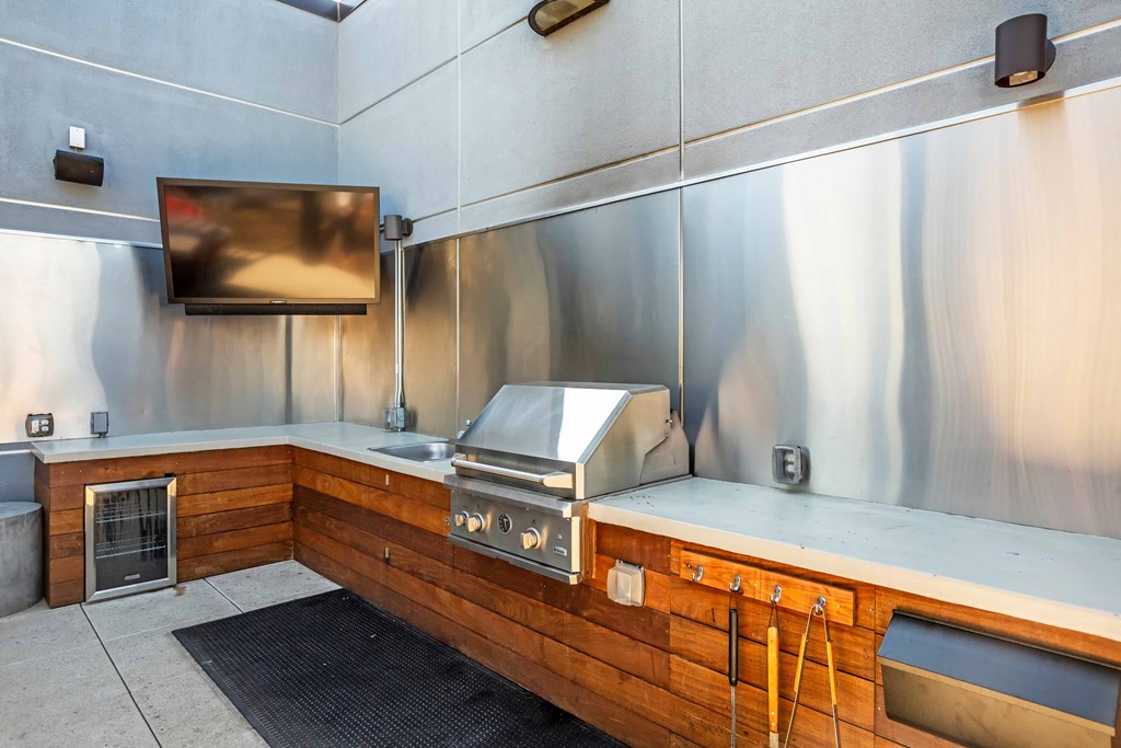 A modern kitchen with stainless steel appliances and wooden accents at Regatta Sloans Lake Apartments, Colorado