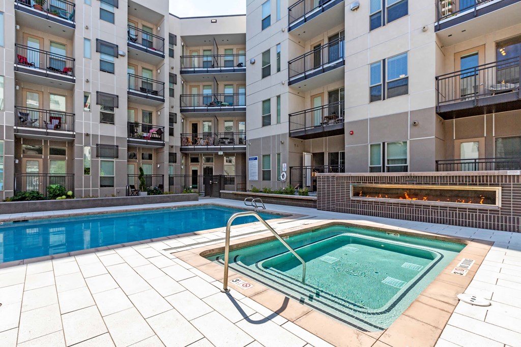 A swimming pool in a courtyard surrounded by apartment buildings at Regatta Sloans Lake Apartments, Colorado, 80204