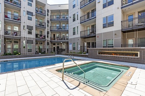 A swimming pool in a courtyard surrounded by apartment buildings at Regatta Sloans Lake Apartments, Colorado, 80204