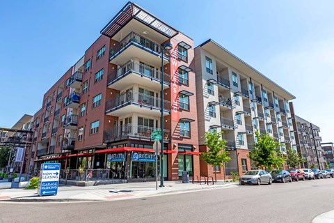 A multi-story apartment building with a red and white sign  at Regatta Sloans Lake Apartments, Denver, Colorado