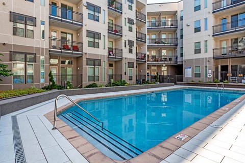 A swimming pool in front of apartment buildings at Regatta Sloans Lake Apartments, Denver, CO, 80204
