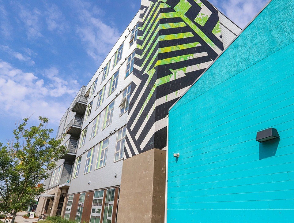 A modern building with a black and white striped facade. at RiDE at RiNo Apartments, Denver 80216