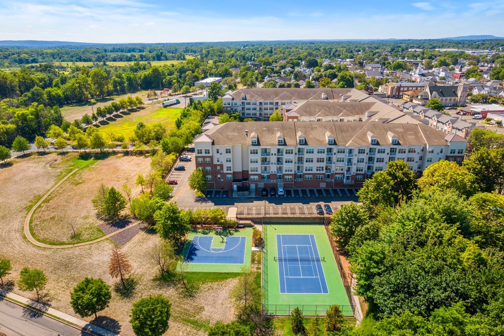 an aerial view of the beautiful property showcasing a half basketball and full tennis court at The Lena, Raritan, New Jersey