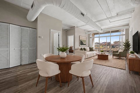 A modern living room with a dining table and chairs.