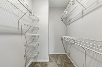 the closet of a bedroom with metal shelves and a mirrored wall at West 130, West Hempstead, New York