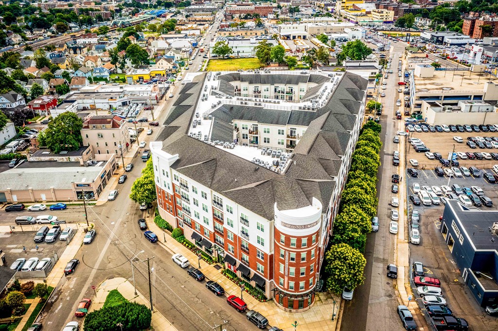 an aerial view of a large brick building with a gray roof at Metro 303, Hempstead