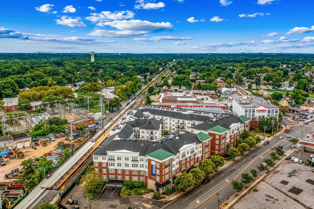 an aerial view of a large city with green trees and a blue sky at West 130, West Hempstead, NY 11552