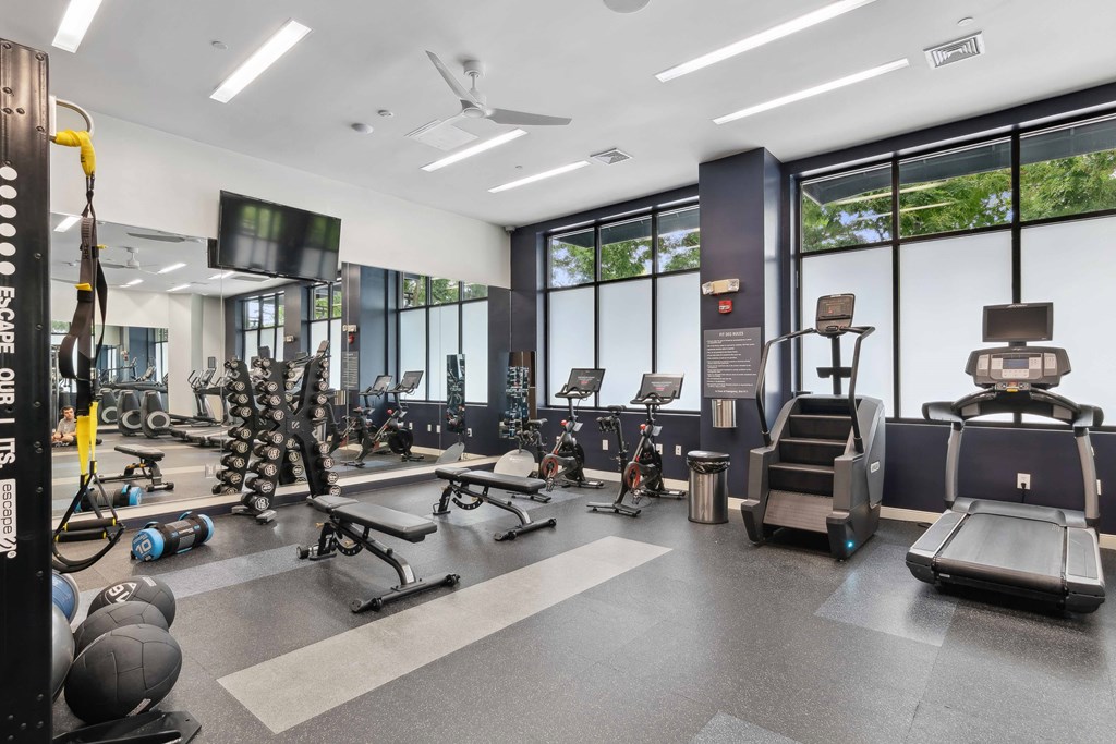 a gym with cardio equipment and weights at Metro 303, New York