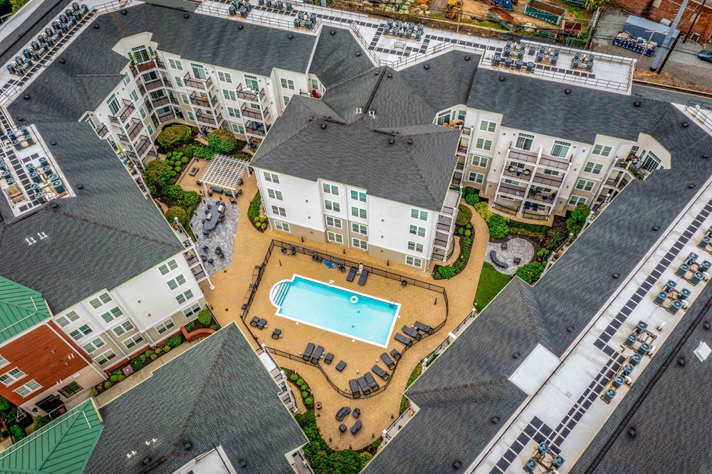 an aerial view of the resort style pool and hot tub at the reserve at south coast apartments at West 130, West Hempstead, 11552