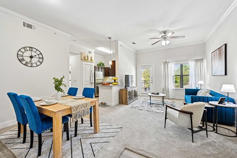 Dining room with table set for six and blue chair at The Laurel at Vintage Park 55+ Apartments, Tomball Texas