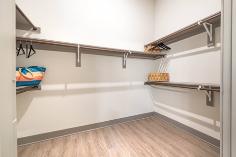 A walk-in closet with shelves and hanging space.at The Bridge at McKinney, Texas