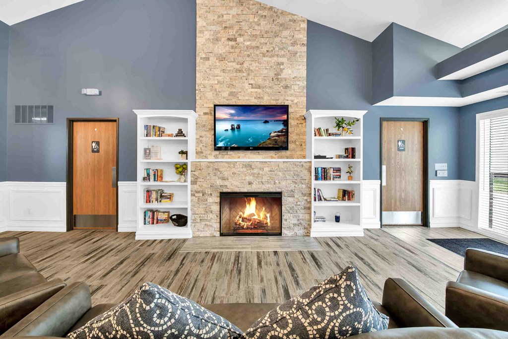 a living room with a fireplace and a tv