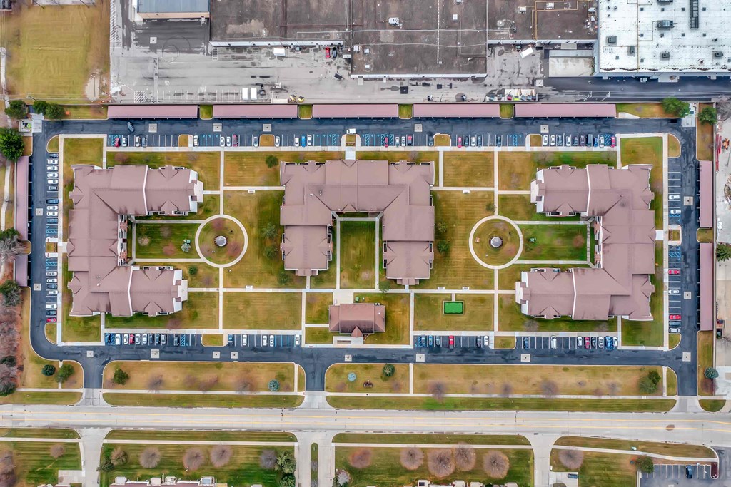 a bird s eye view of a city with buildings and a parking lot