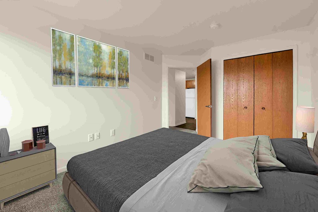 a bedroom with a bed and a painting on the wall