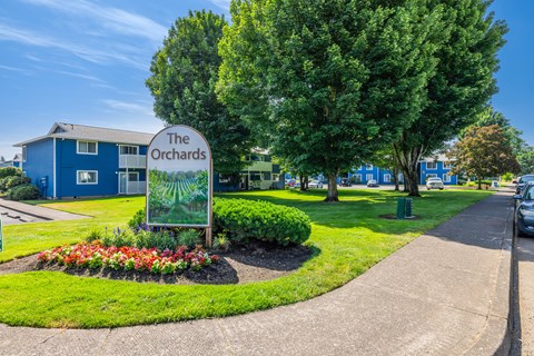 A blue building with a sign that says The Orchards.