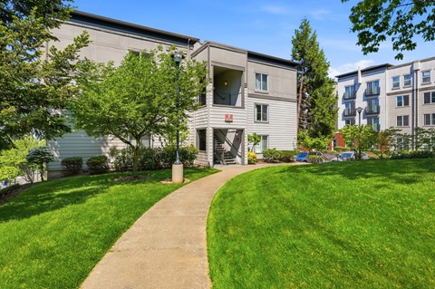 A building with a green lawn in front of it.