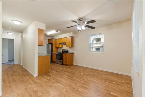 A kitchen with wooden cabinets and a ceiling fan.