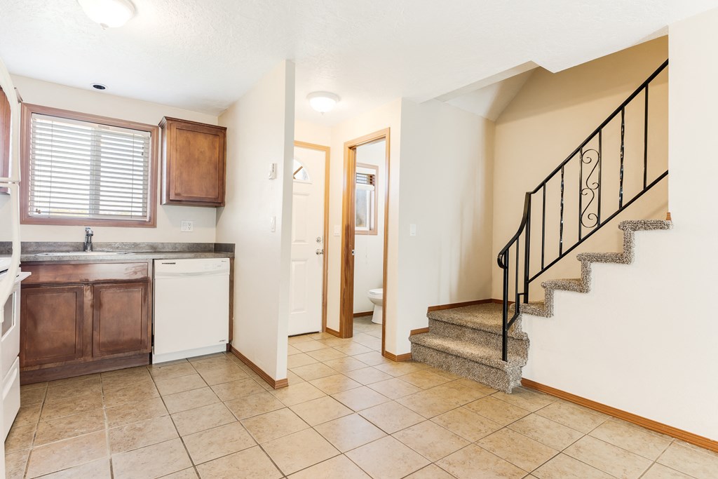 a kitchen with a sink and a toilet