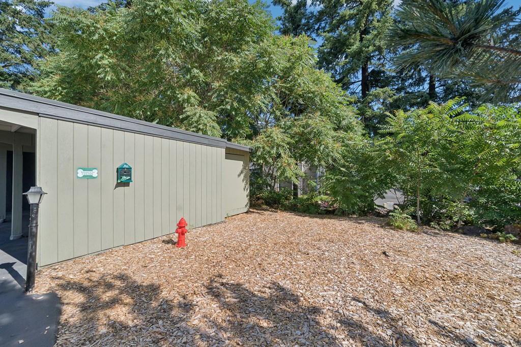 A building with a red fire hydrant in front of it.