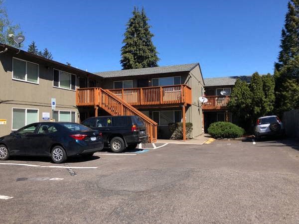a parking lot with cars in front of a building
