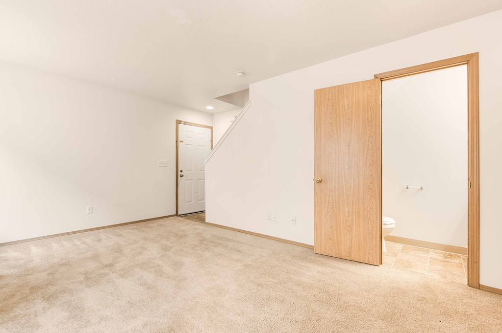 a bedroom with a door to a bathroom