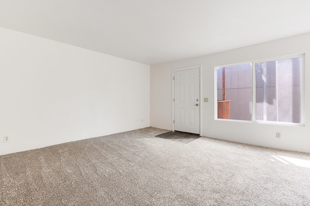 a empty room with a door and a window