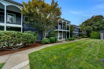 a view of a building with a grassy area in front of it Sunset Station Apartments Portland Oregon 