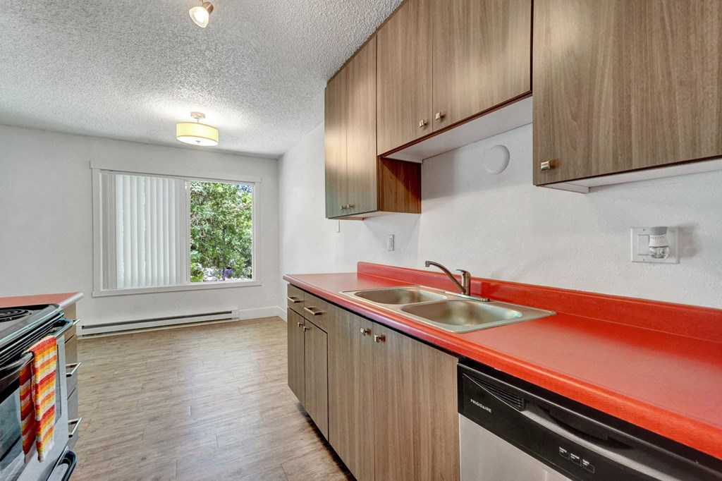 a kitchen with orange countertops and wooden cabinets