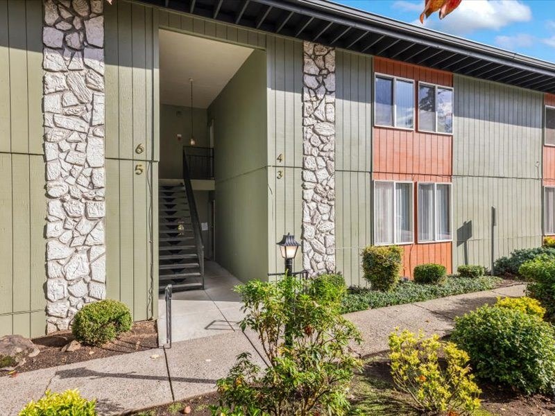 the entrance to a building with stairs and a sidewalk