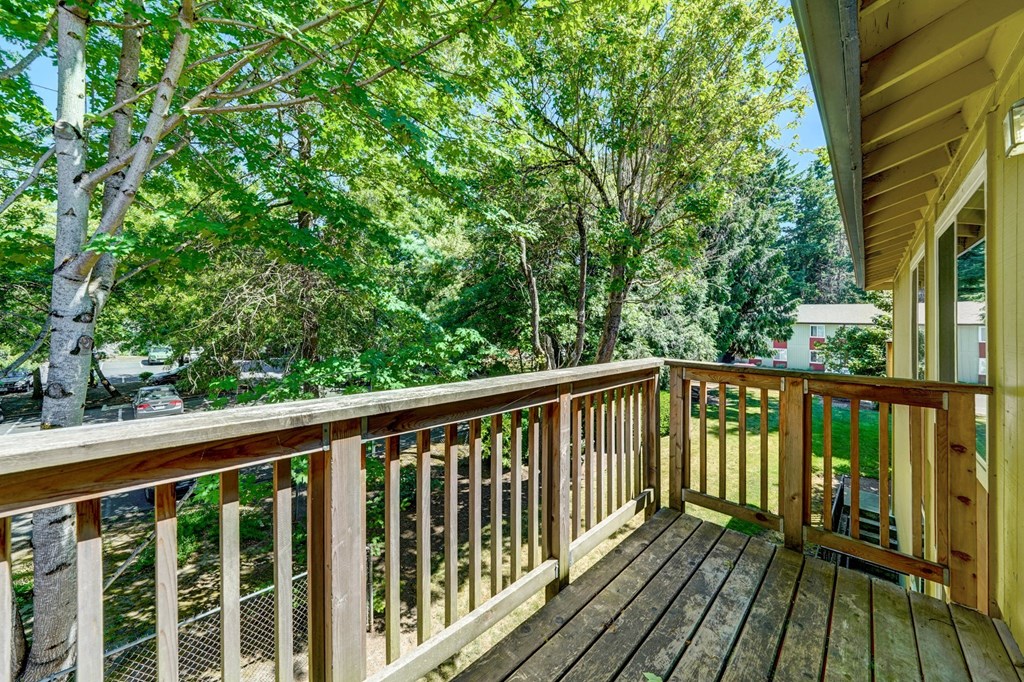 a large deck with a view of the trees