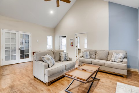 A living room with a white couch and a coffee table.