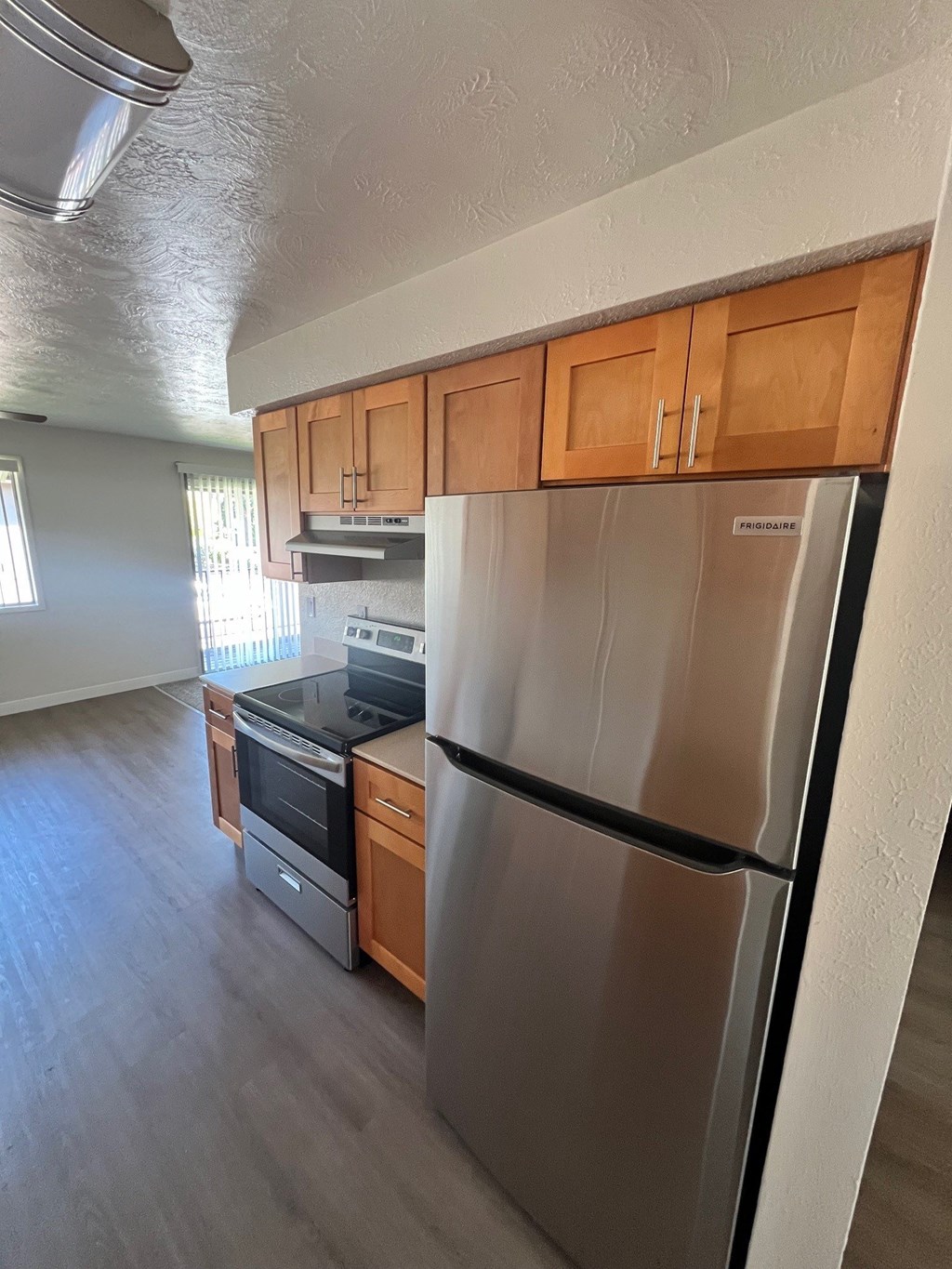 A kitchen with a stainless steel refrigerator, oven, and microwave.
