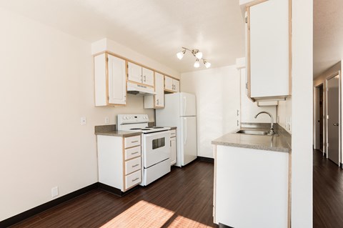 a kitchen with white appliances and white cabinets