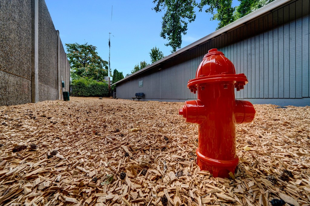 a red fire hydrant in front of a building Sunset Station Apartments Portland Oregon 