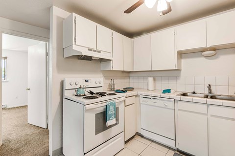 a white kitchen with white appliances and white cabinets
