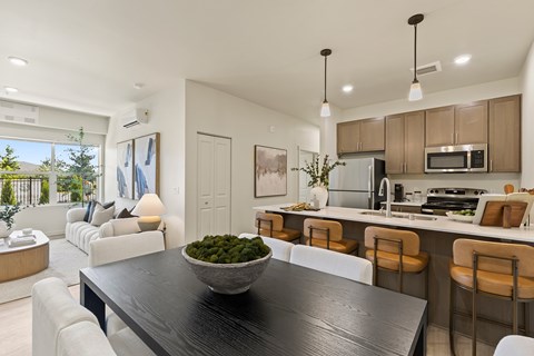 A modern kitchen with a dining table and chairs.