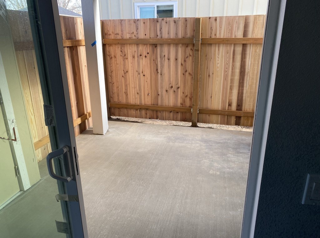 A wooden fence is in the middle of a room.