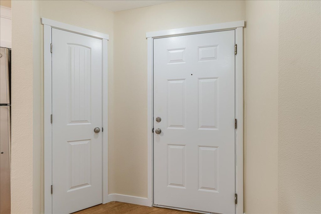 Two white doors in a room.