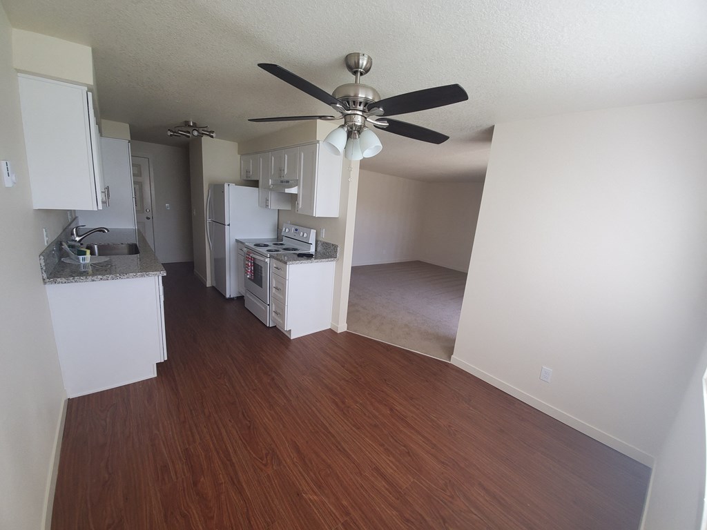 an example of a kitchen and living room in an apartment
