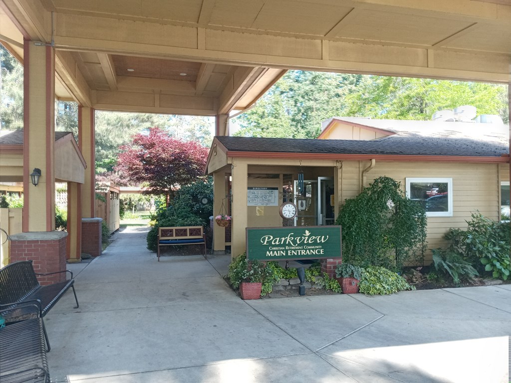 a porch with a sign in front of a house