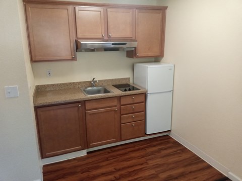 a kitchen with a sink and a refrigerator
