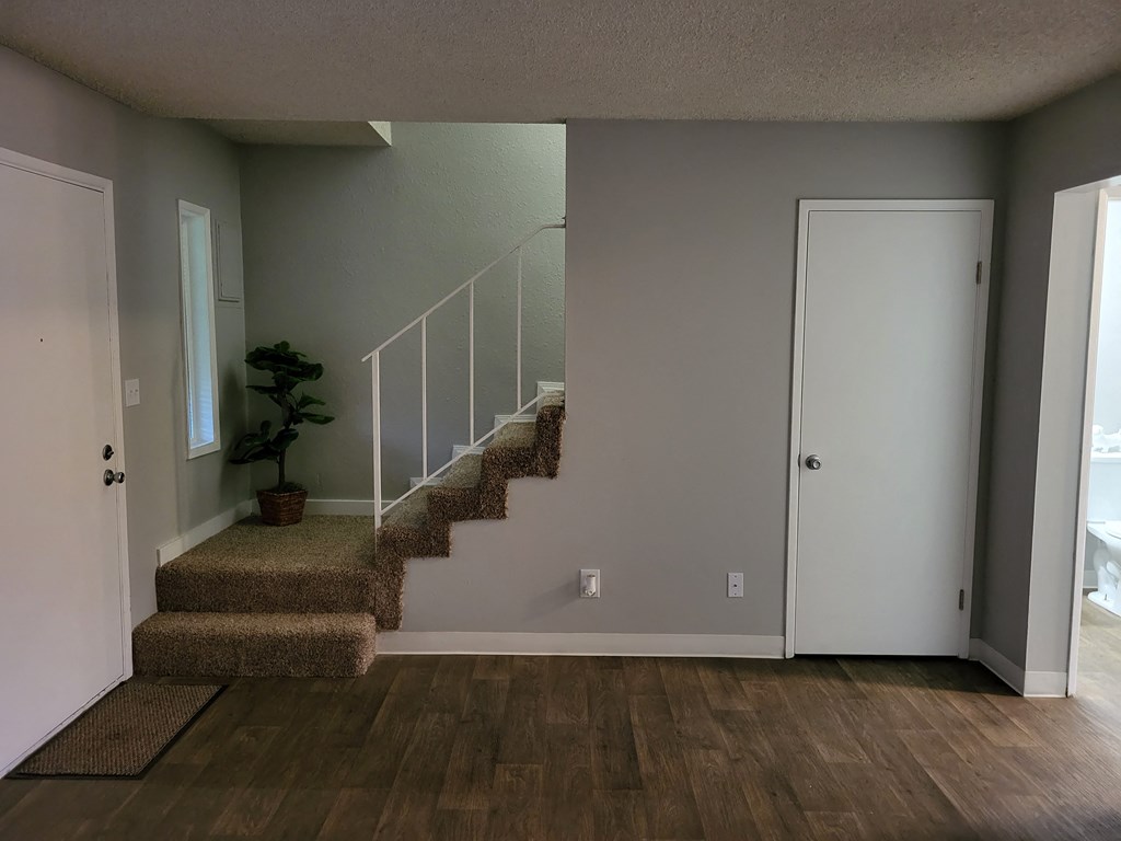 a stairwell in a home with a door and a staircase