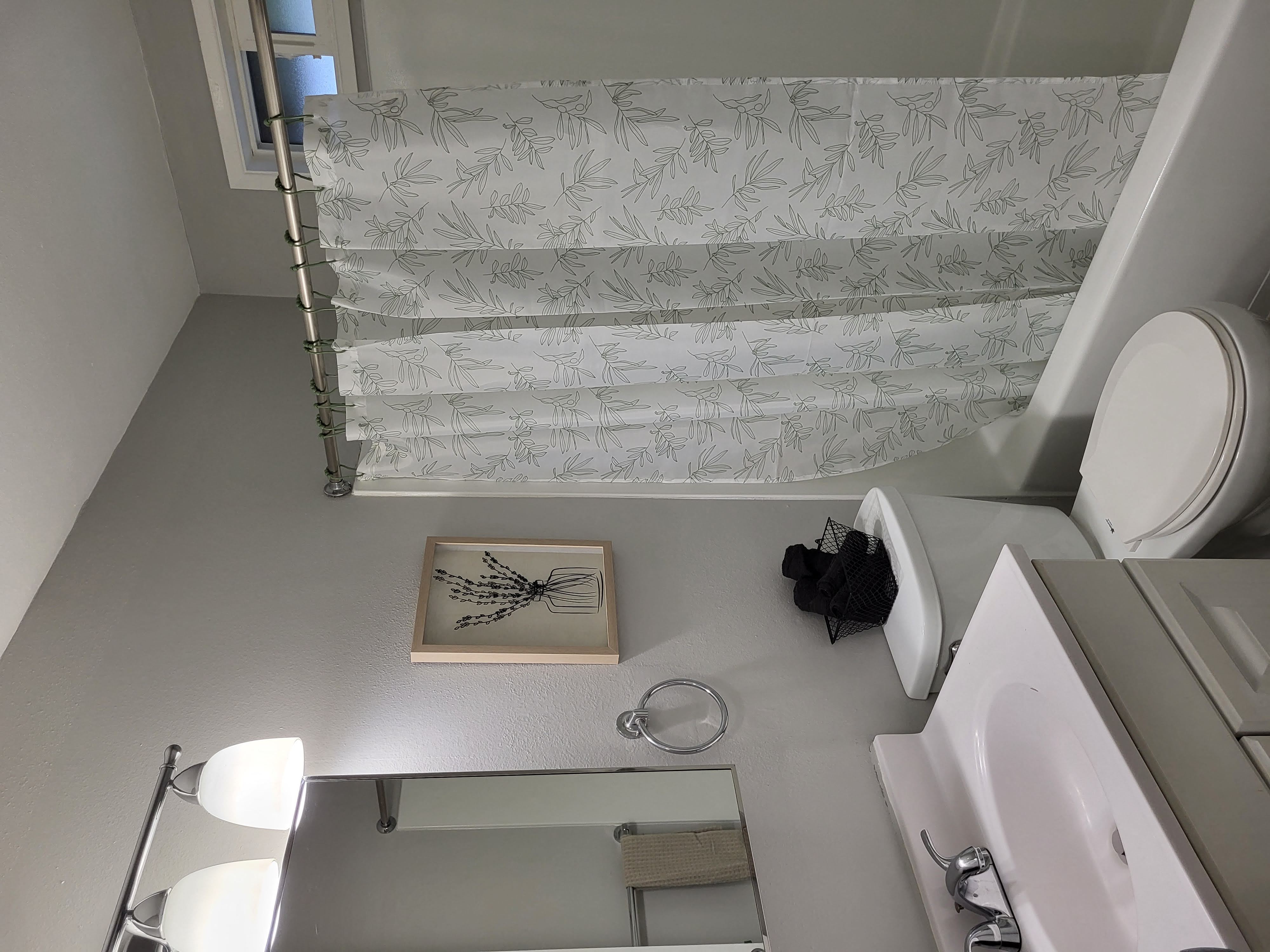 a small bathroom with a toilet and a sink and a shower