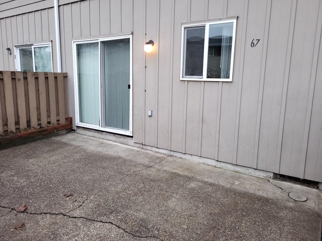 the entrance of a house with a patio door and a backdoor