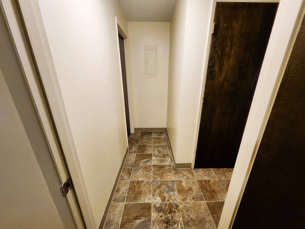 Nell Anna Court hallway with tiled flooring and white walls.