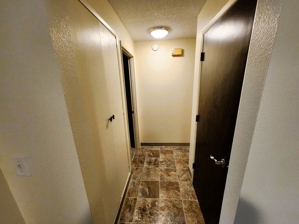 Nell Anna Court hallway with a tiled floor and a light on the ceiling.