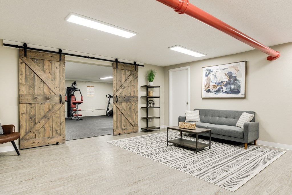 a living room with a couch and sliding barn doors